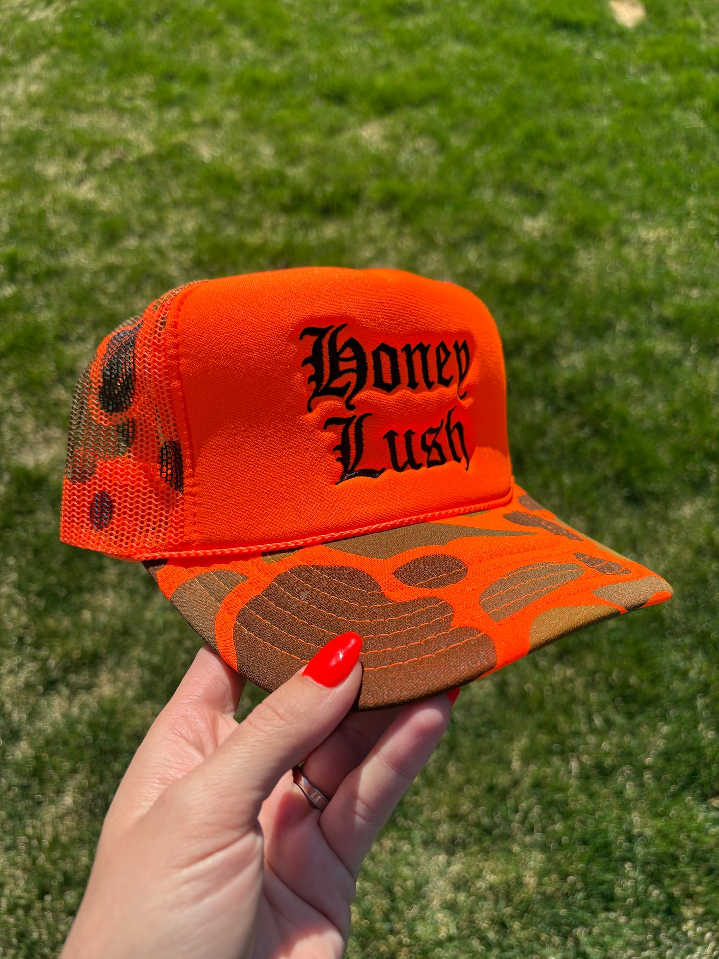 Honey Lush Embroidered Foam Front Trucker Hat: Neon Orange Camo